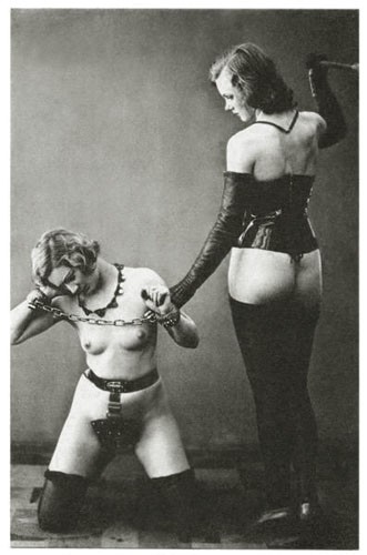 A woman spanking another woman with a violin bow, a notably unconventional implement